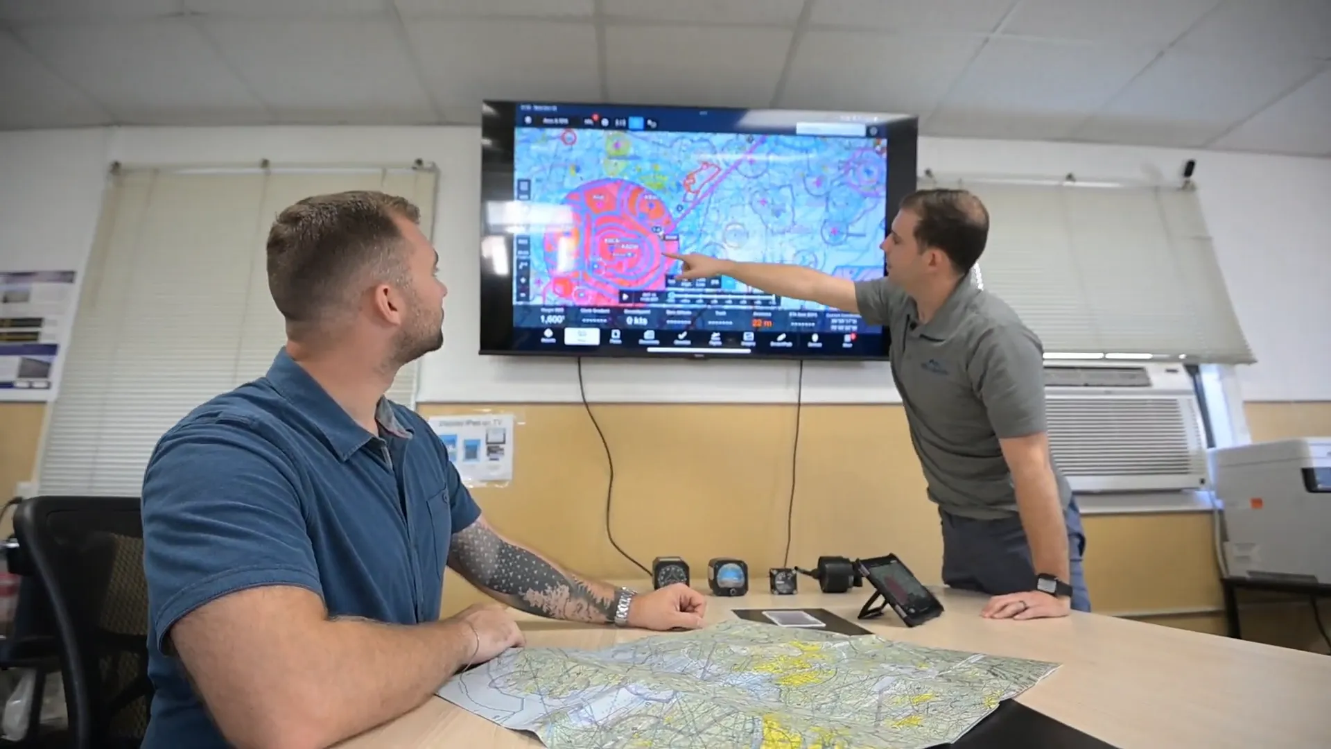 Ground school instructor explaining aviation charts