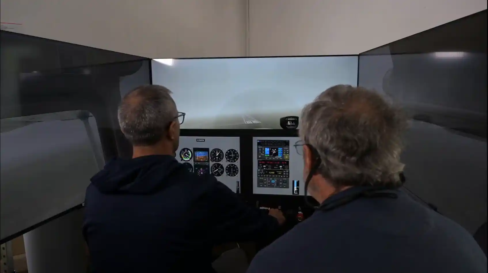 Instructor and pilot flying a low-visibility approach in the simulator