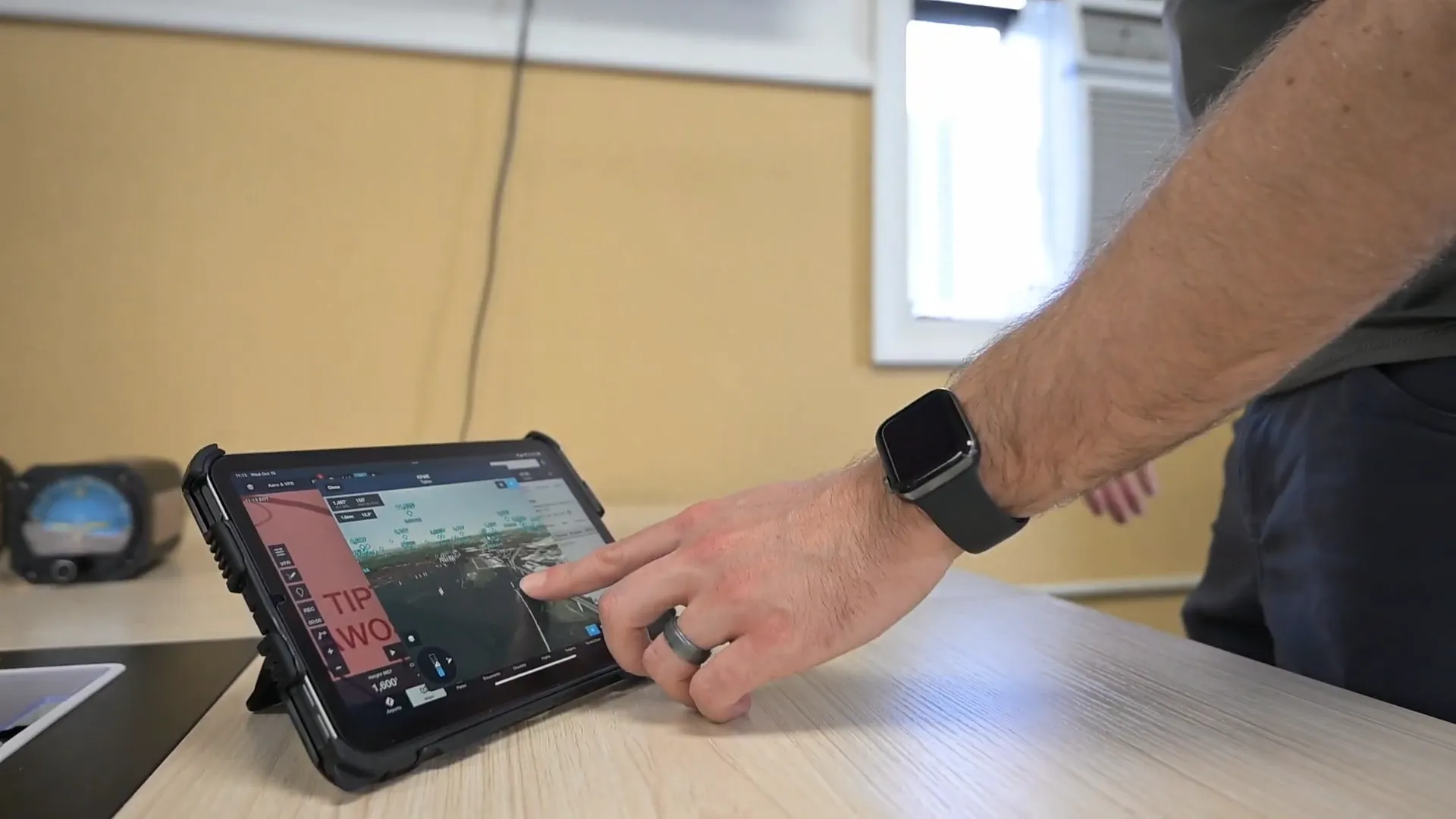 Pilot planning a flight on a tablet during ground training at Solid Ground Aviation