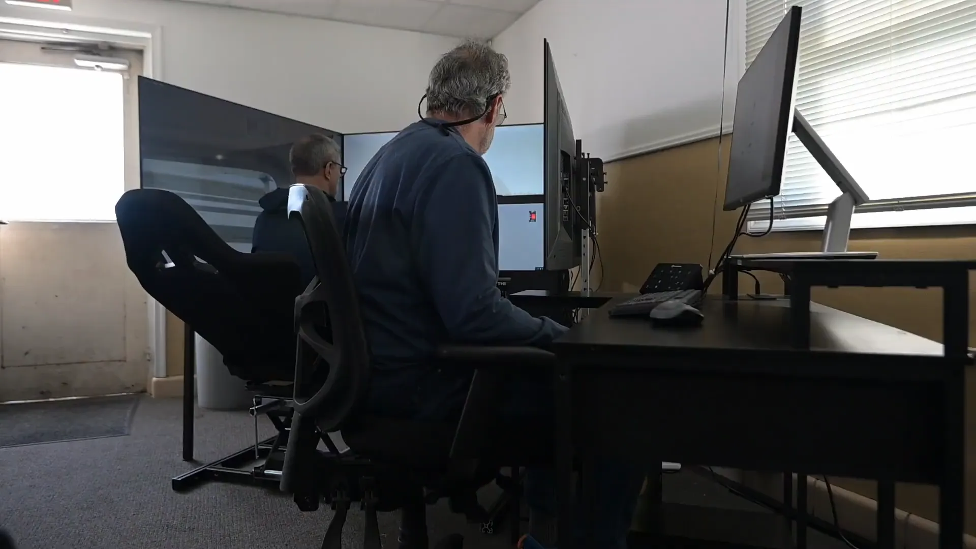 Instructor and returning pilot in the Solid Ground simulator